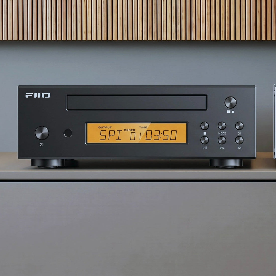 FiiO DP11 CD player in black on a living-room sideboard