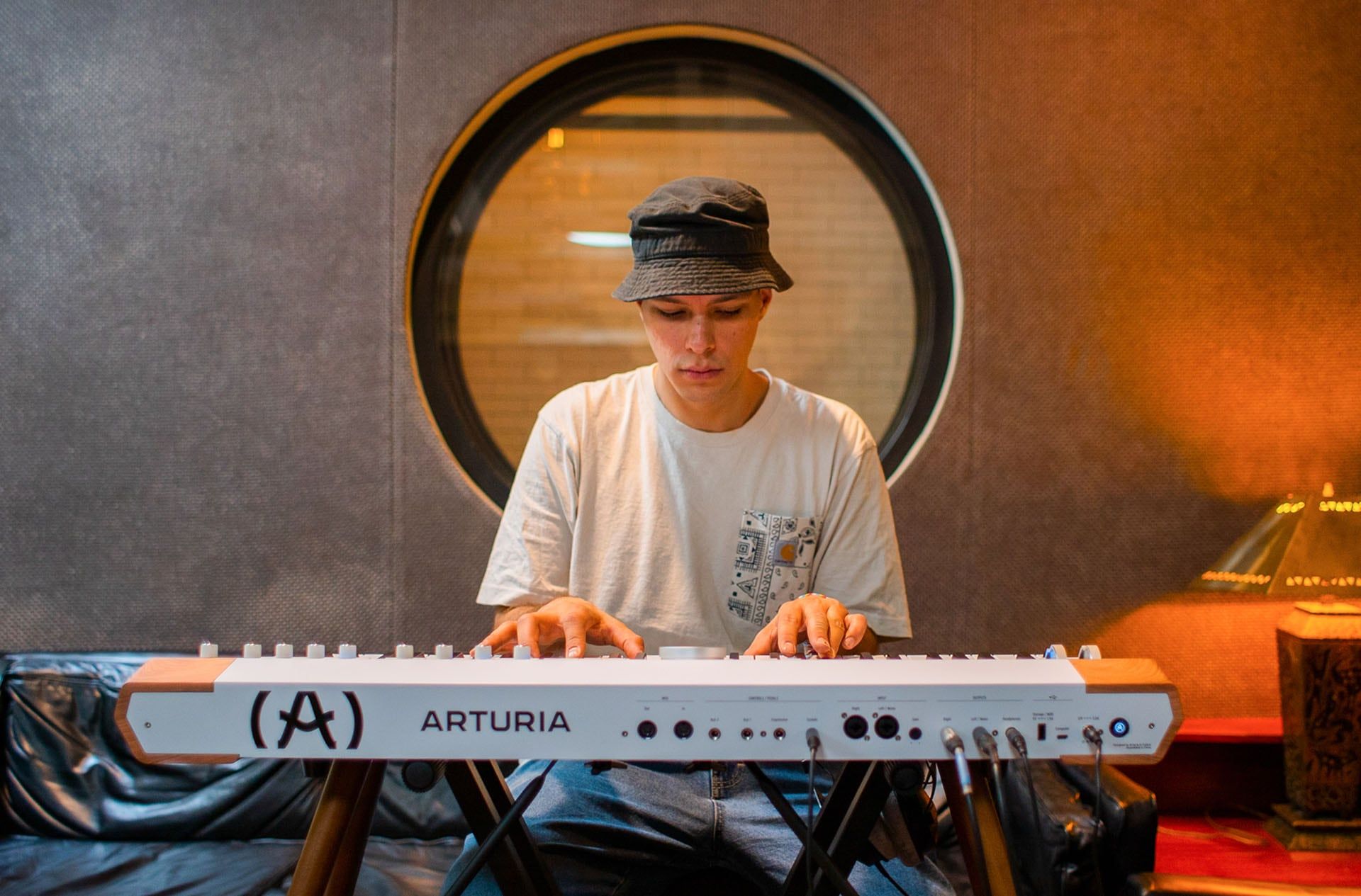 Arturia AstroLab 61 performance keyboard with black and white keys, compact design, and control knobs for music production.