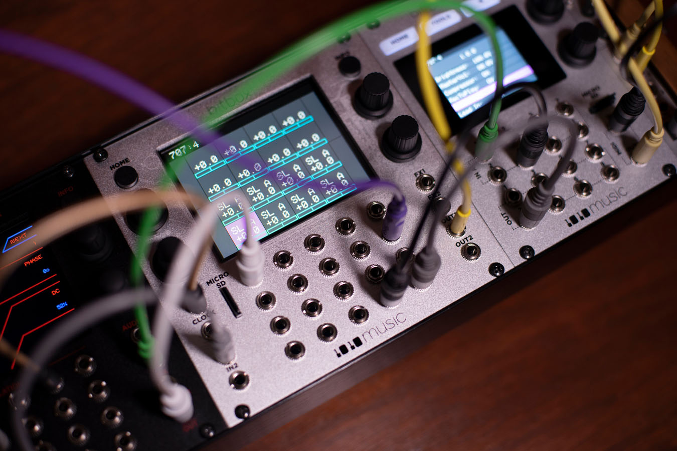 1010music Bitbox MK2 semi-modular synthesizer with colorful knobs and patch points, used in a music production setup.