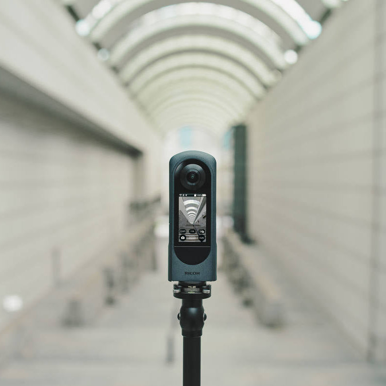 Ricoh Theta X 360-degree video camera with dual lenses and compact design, ideal for immersive 3D content creation.