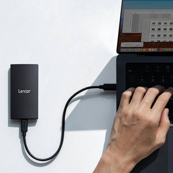 Lexar SL300 portable external SSD drive with sleek black design and compact size, suitable for fast data storage and transfer.
