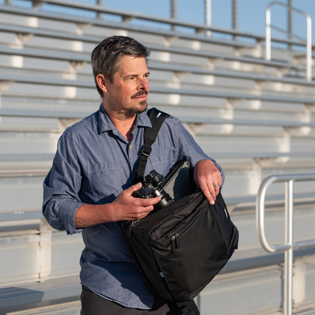 Think Tank Shape Shifter video equipment bag with padded compartments and adjustable shoulder strap, black camera gear case.