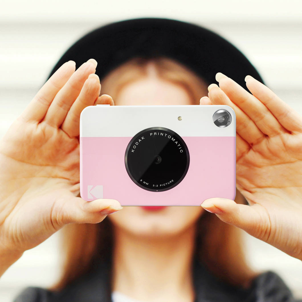 Kodak Printomatic instant compact camera with colorful design and lens, ready to capture and print photos instantly.