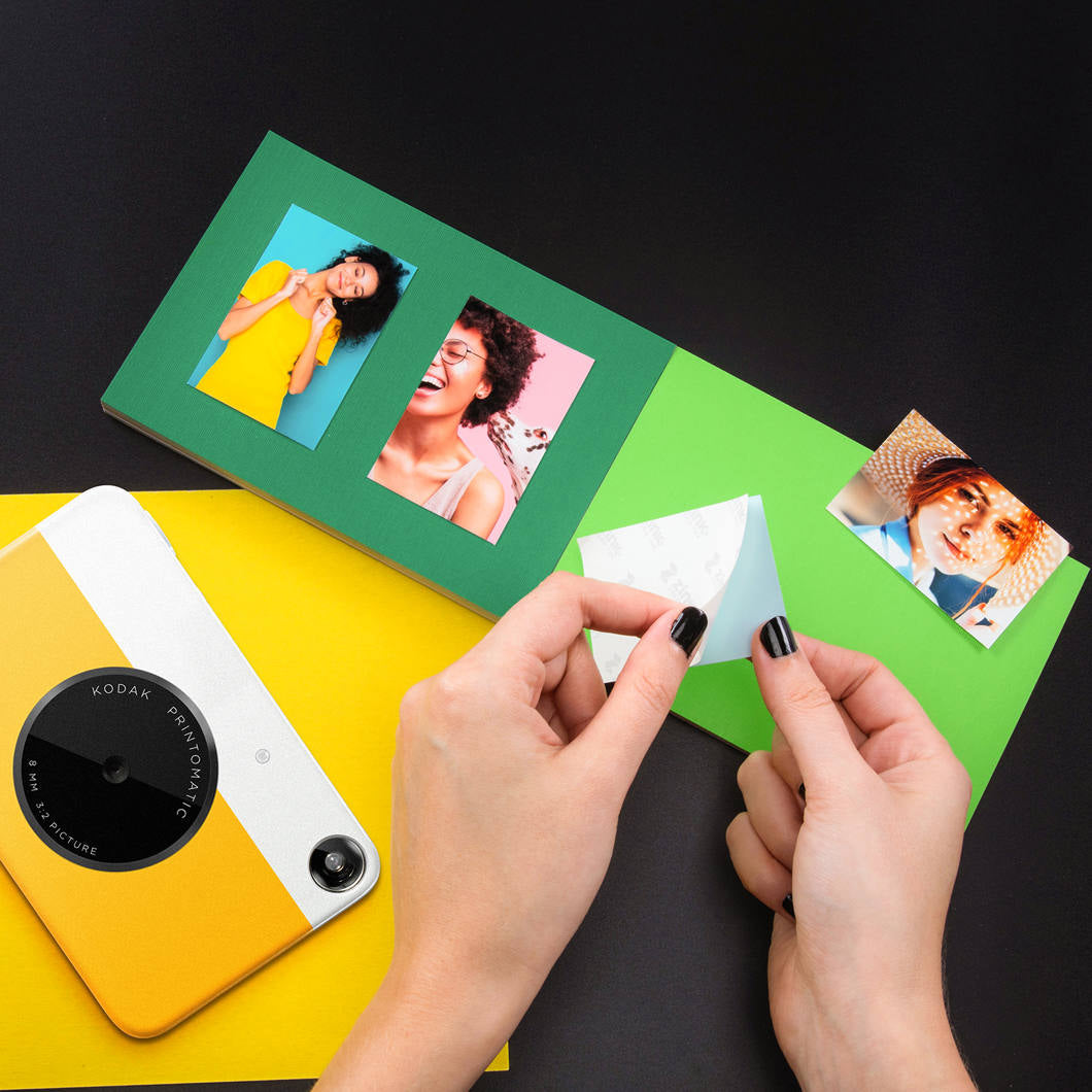 Kodak Printomatic instant compact camera with black body, ready to capture and print photos instantly.