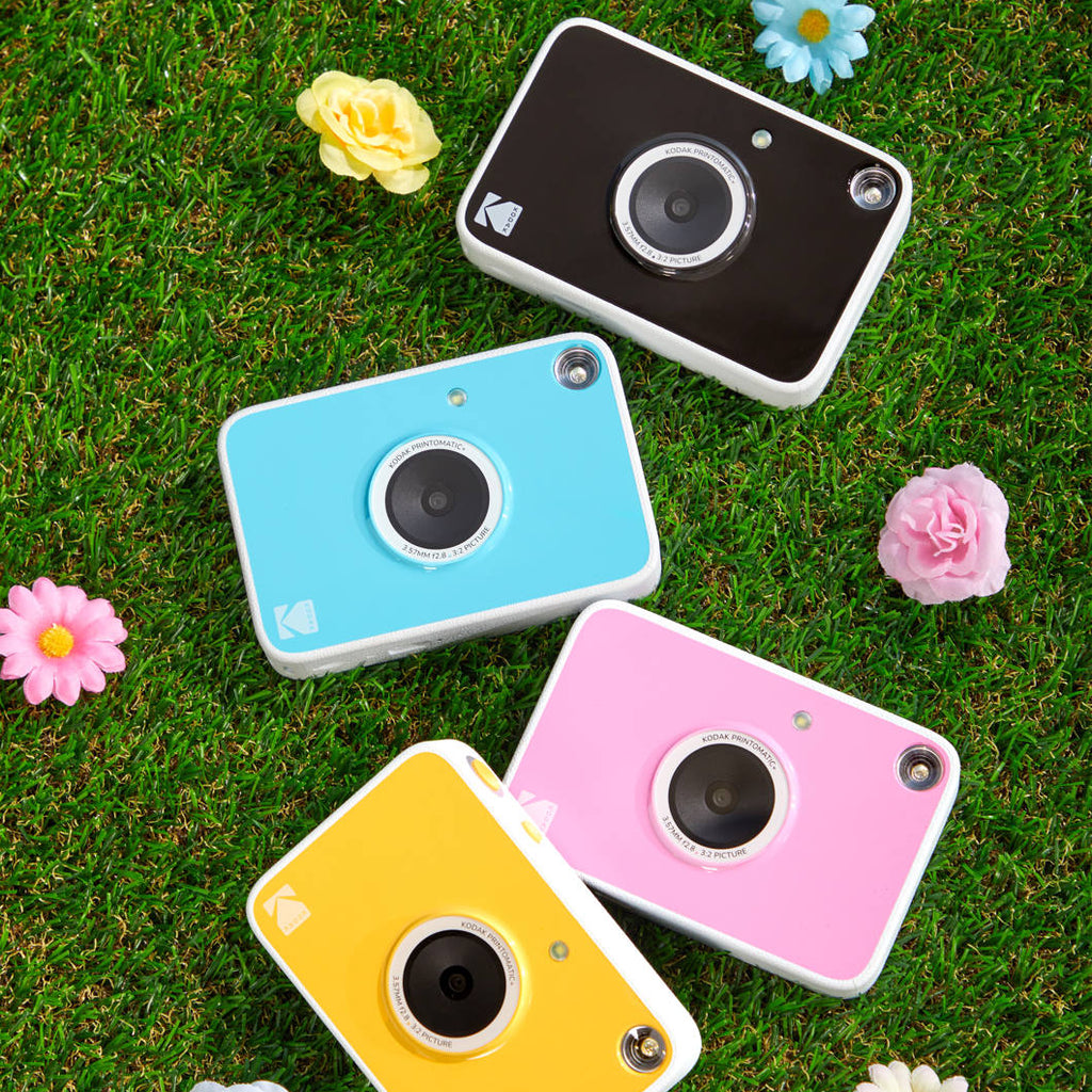 Kodak Printomatic+ instant compact camera with colorful design, ready to capture and print photos instantly.
