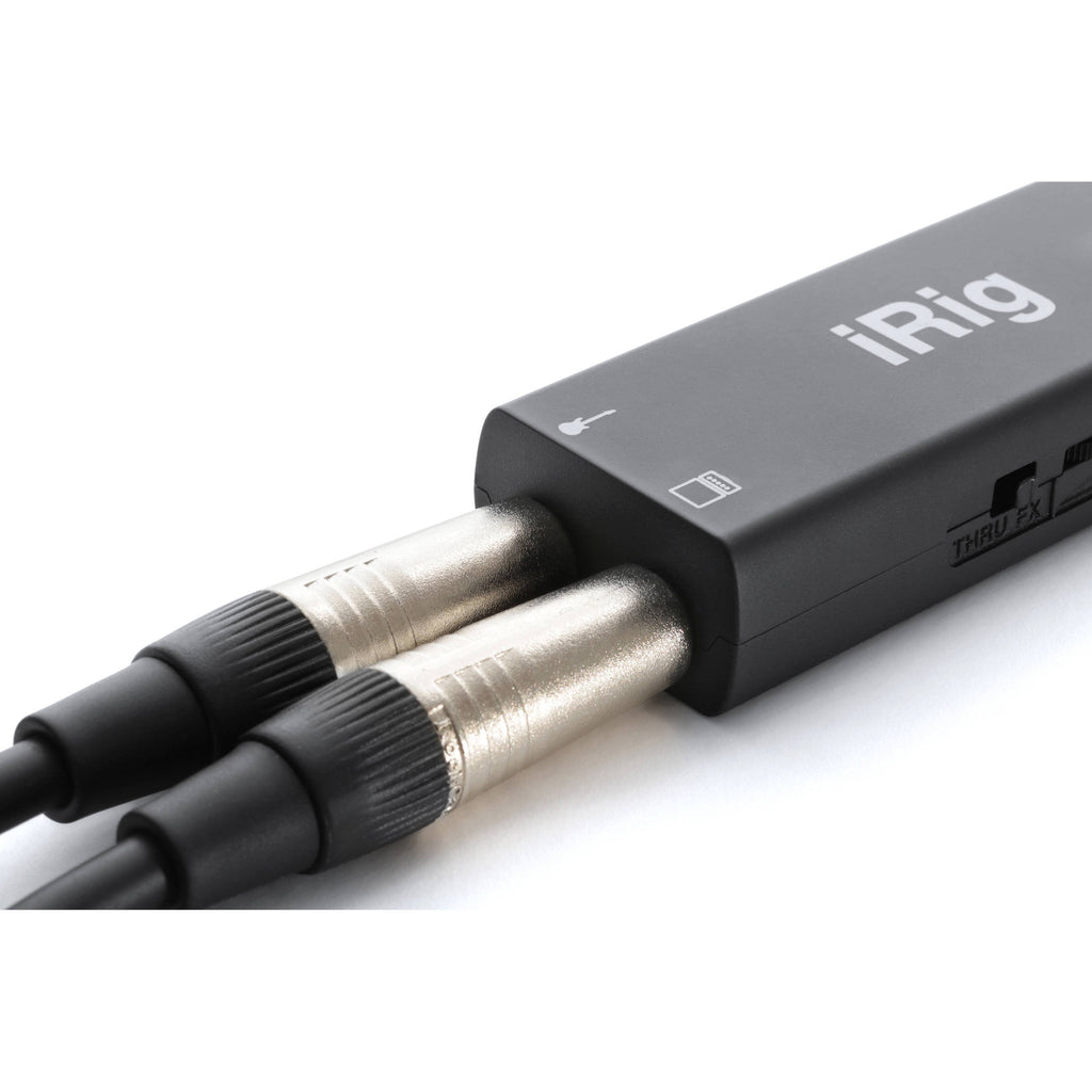 IK Multimedia iRig HD 2 audio interface with guitar cable and connection ports on a clean surface.