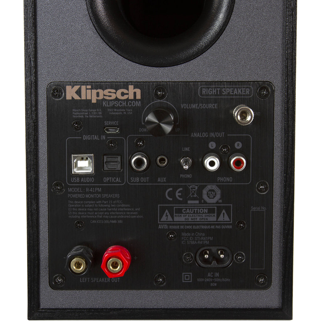 Pair of Klipsch R-41PM active bookshelf speakers with wooden finish, featuring front speaker grilles and control knobs.