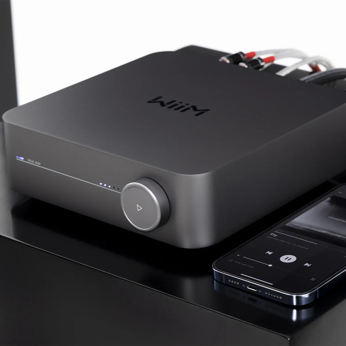 WiiM AMP music streamer device with sleek black design, front display, and connectivity ports for high-quality audio streaming.