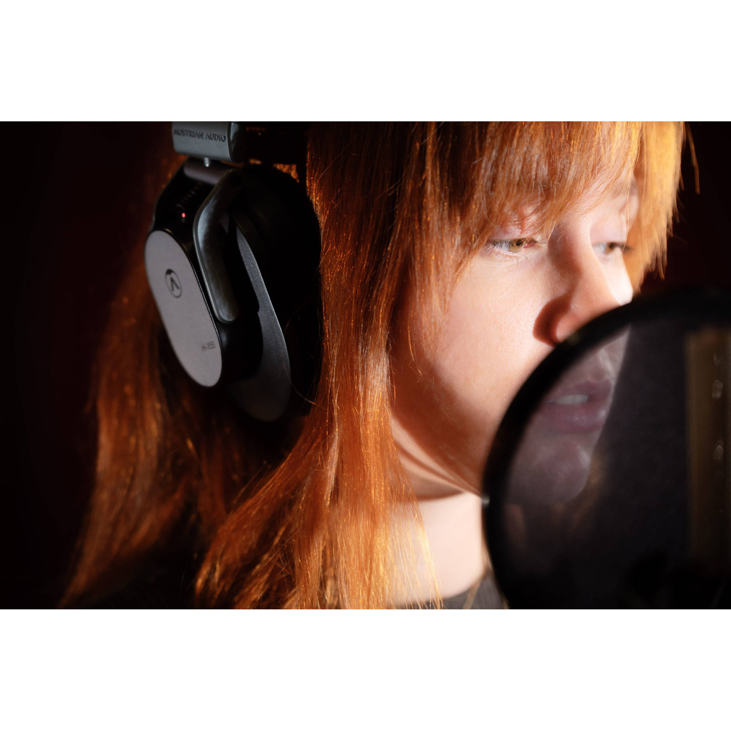 Austrian Audio Hi-X55 studio headphones with over-ear design and cushioned headband, black color, on a white background.