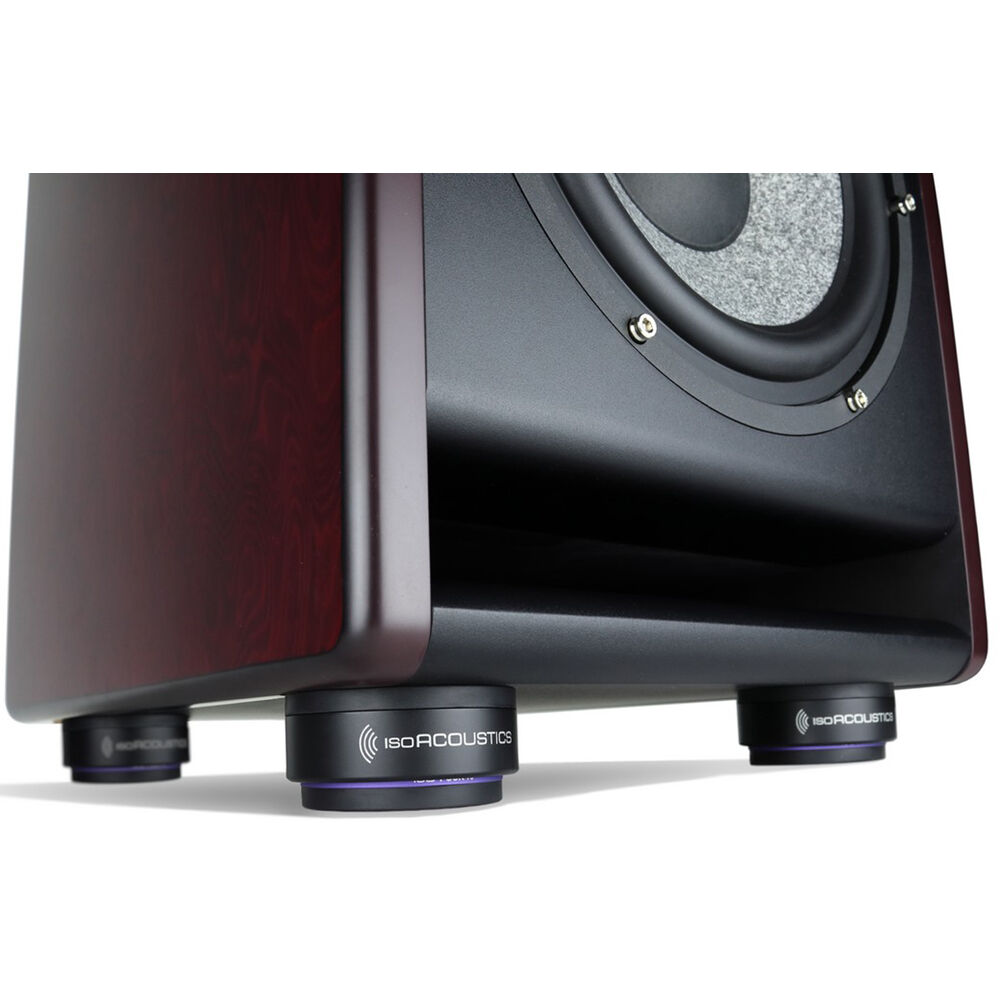 IsoAcoustics ISO-Puck 76 studio monitor stand isolators on a surface, designed to improve audio clarity and reduce vibrations.