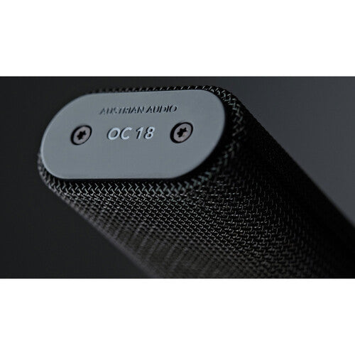 Austrian Audio OC18 condenser microphone studio set with microphone and accessories on a desk.