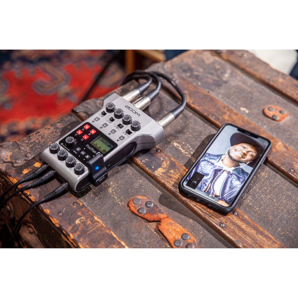 Zoom BTA-2 Bluetooth adapter for PodTrak P4 and P8 recorders, shown connected with the device for wireless audio streaming.