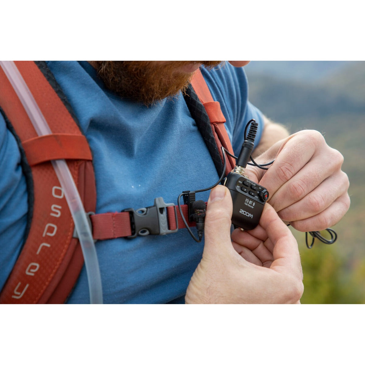Zoom F2 digital recorder with compact design, featuring multiple input options and built-in microphones for high-quality audio recording.