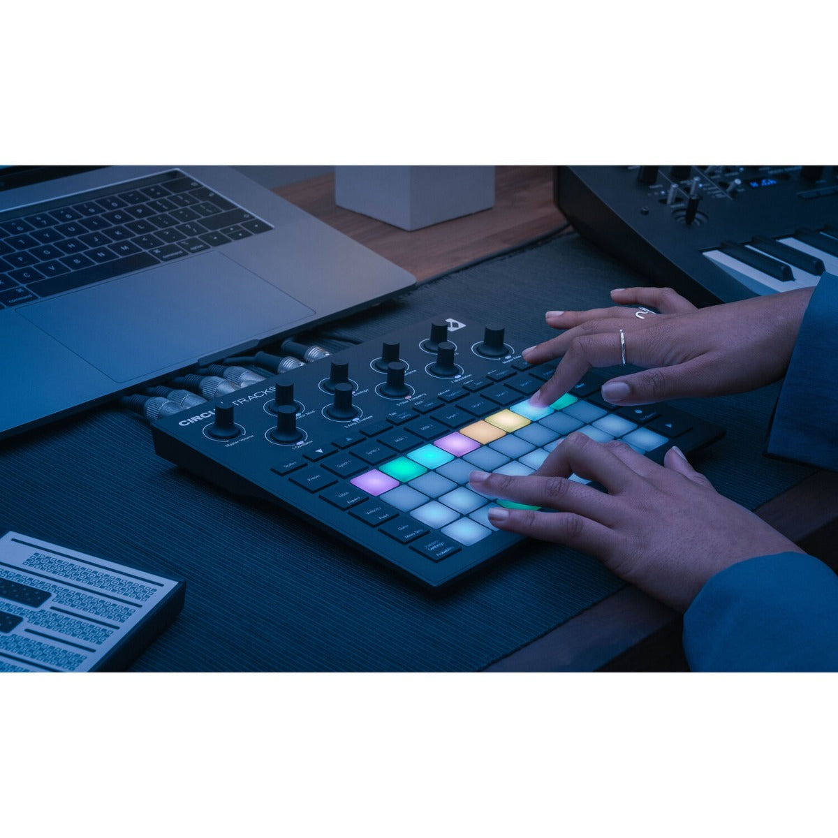Novation Circuit Tracks sequencer with grid controller and buttons, black device for music production and beat making.