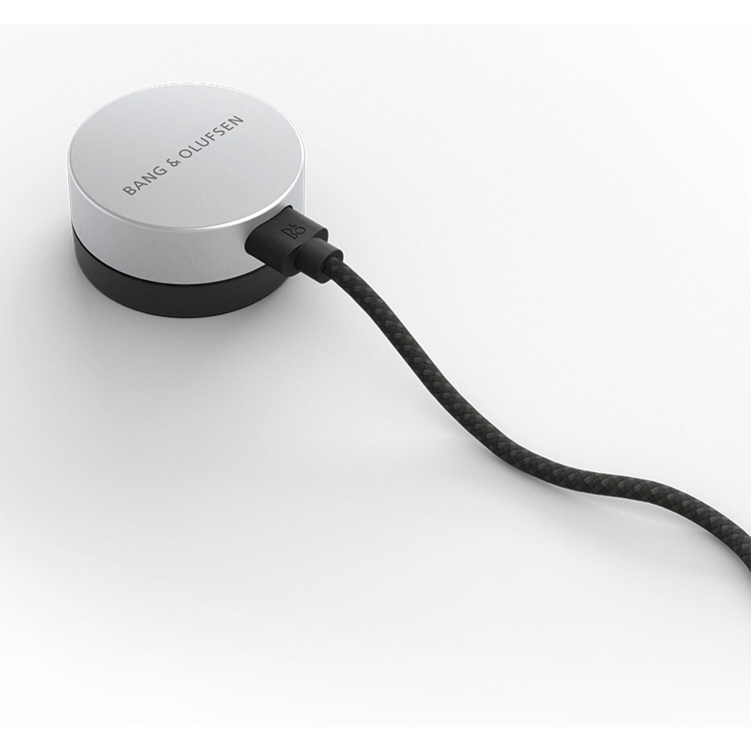 Bang & Olufsen Beosound Level wireless speaker in black, showing its sleek cylindrical design and fabric-covered exterior.