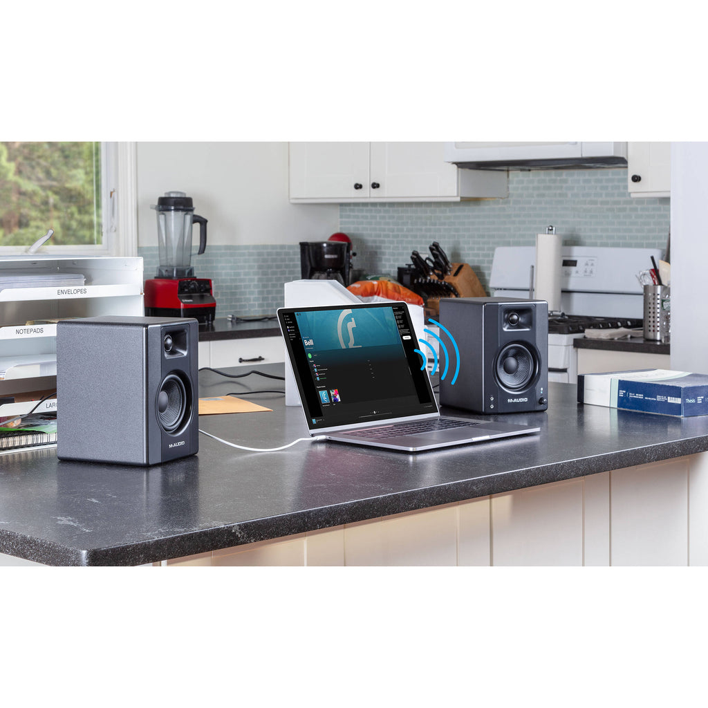 M-Audio BX3 BT desktop speakers with black finish, showing front grille and control knobs on top.