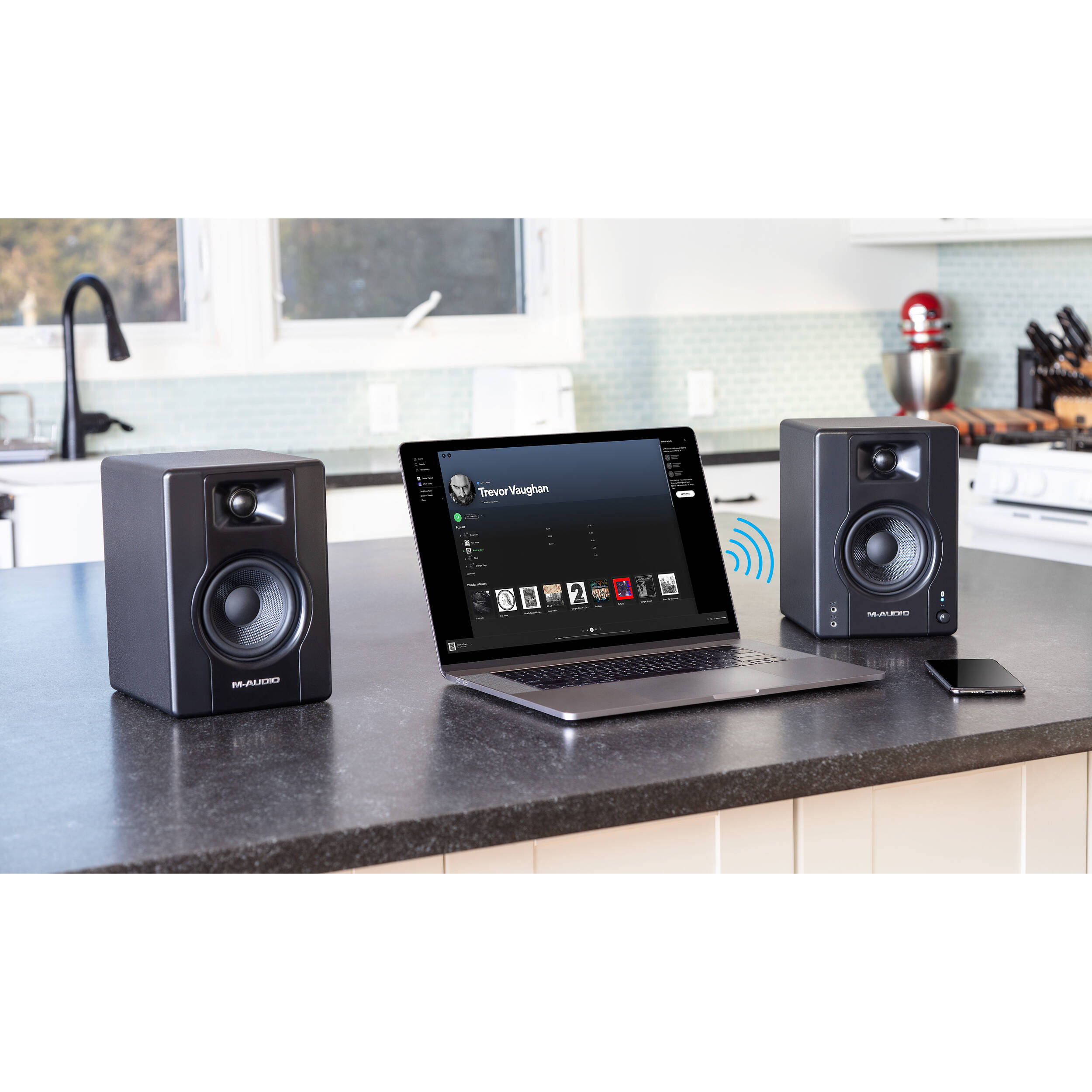 M-Audio BX4 BT desktop speakers with black finish, compact design, and control knobs visible on the front panel.