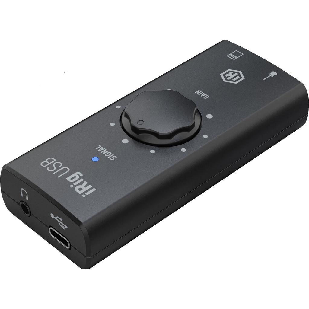 IK Multimedia iRig USB audio interface connected to a computer, showing input ports and compact design for mobile recording.