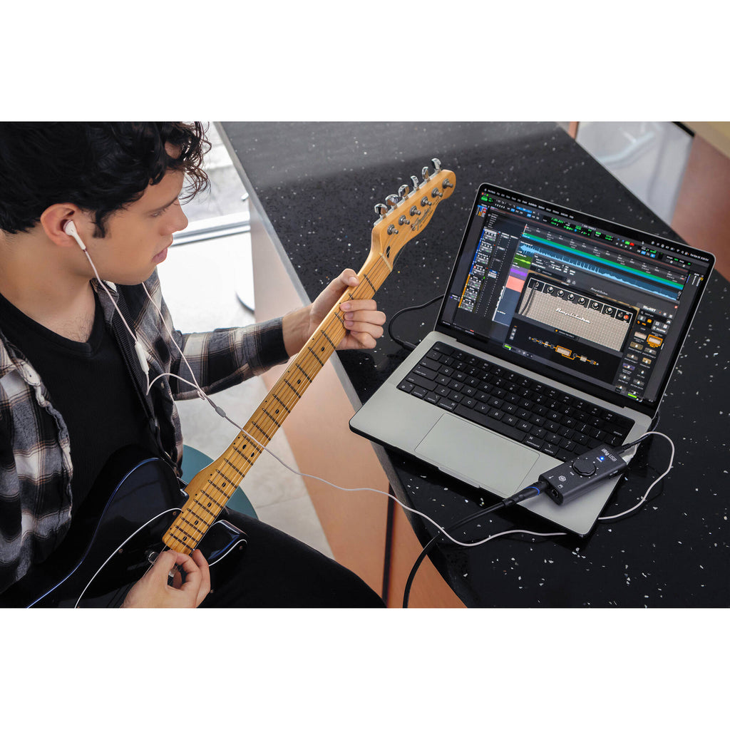 IK Multimedia iRig USB audio interface with input and output ports for connecting musical instruments and microphones to a computer.