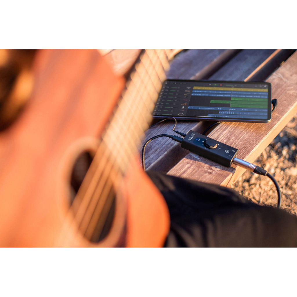 IK Multimedia iRig USB audio interface with input and output ports on a sleek black device.