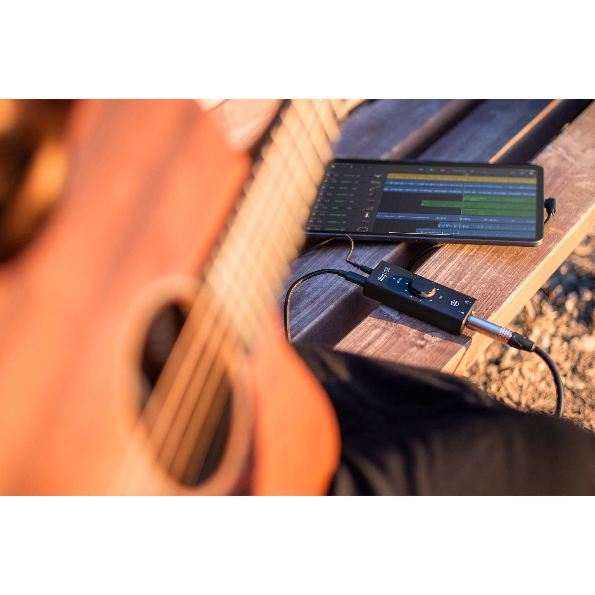 IK Multimedia iRig USB audio interface with input and output ports on a sleek black device.