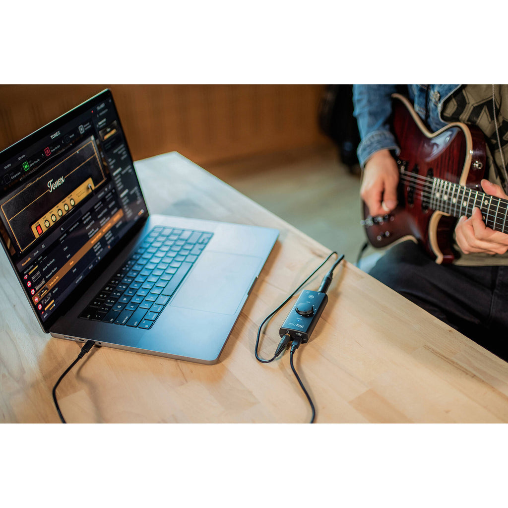 IK Multimedia iRig USB audio interface with input and output ports, compact design, and professional audio connectivity.