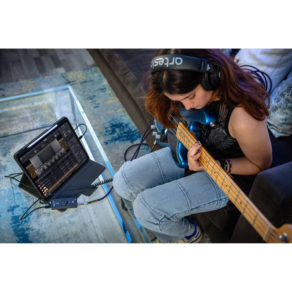 IK Multimedia iRig USB audio interface with input and output ports, compact design, used for mobile and computer audio recording.
