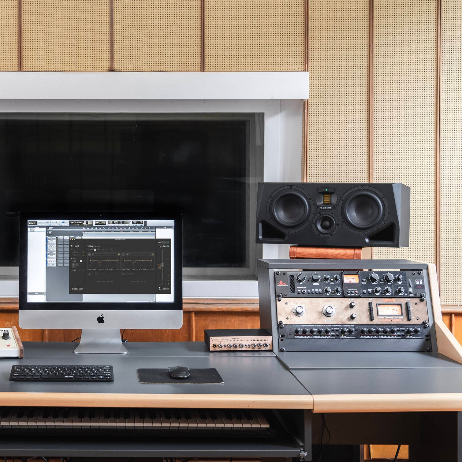 Adam Audio A77H mid-field and main studio monitor speakers shown from front, featuring sleek black design and speaker cones.