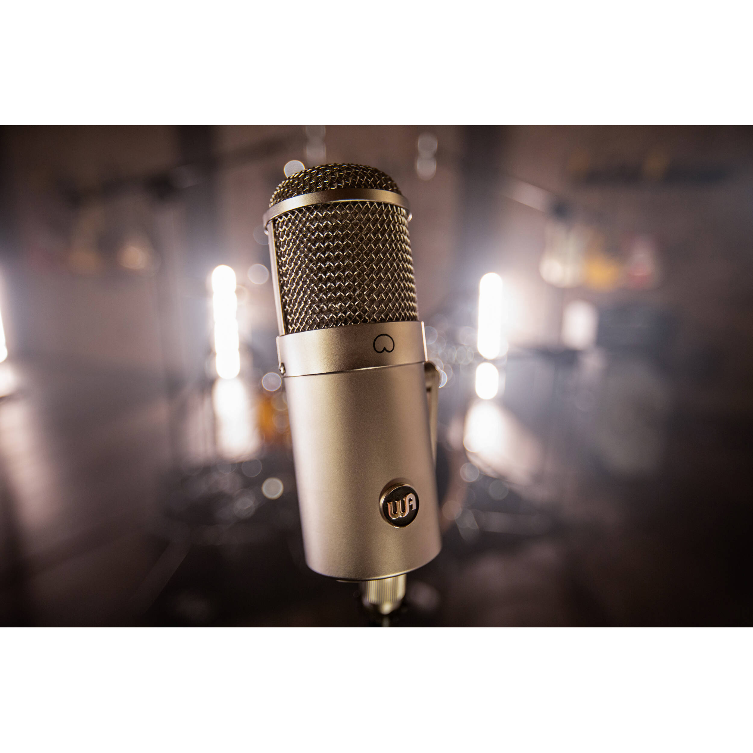 Warm Audio WA-47F condenser microphone with vintage-style metal body and gold finish, designed for studio recording.