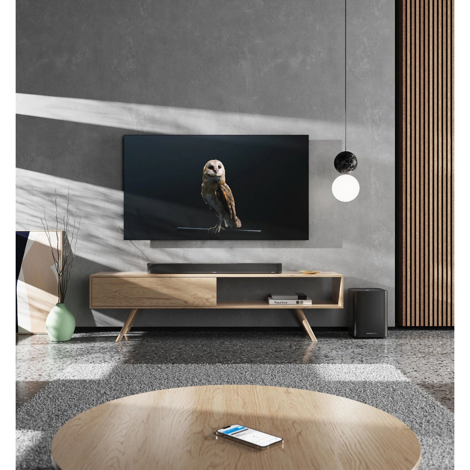 Sennheiser Ambeo Soundbar Plus with sleek black design, featuring multiple speaker drivers and a modern TV sound system setup.