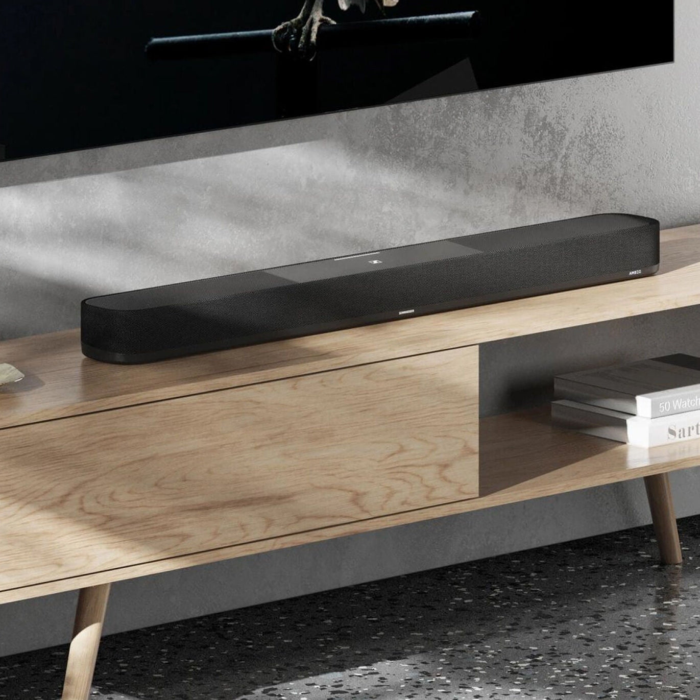 Sennheiser Ambeo Soundbar Plus showcasing sleek black design with multiple speaker drivers and control buttons on top.