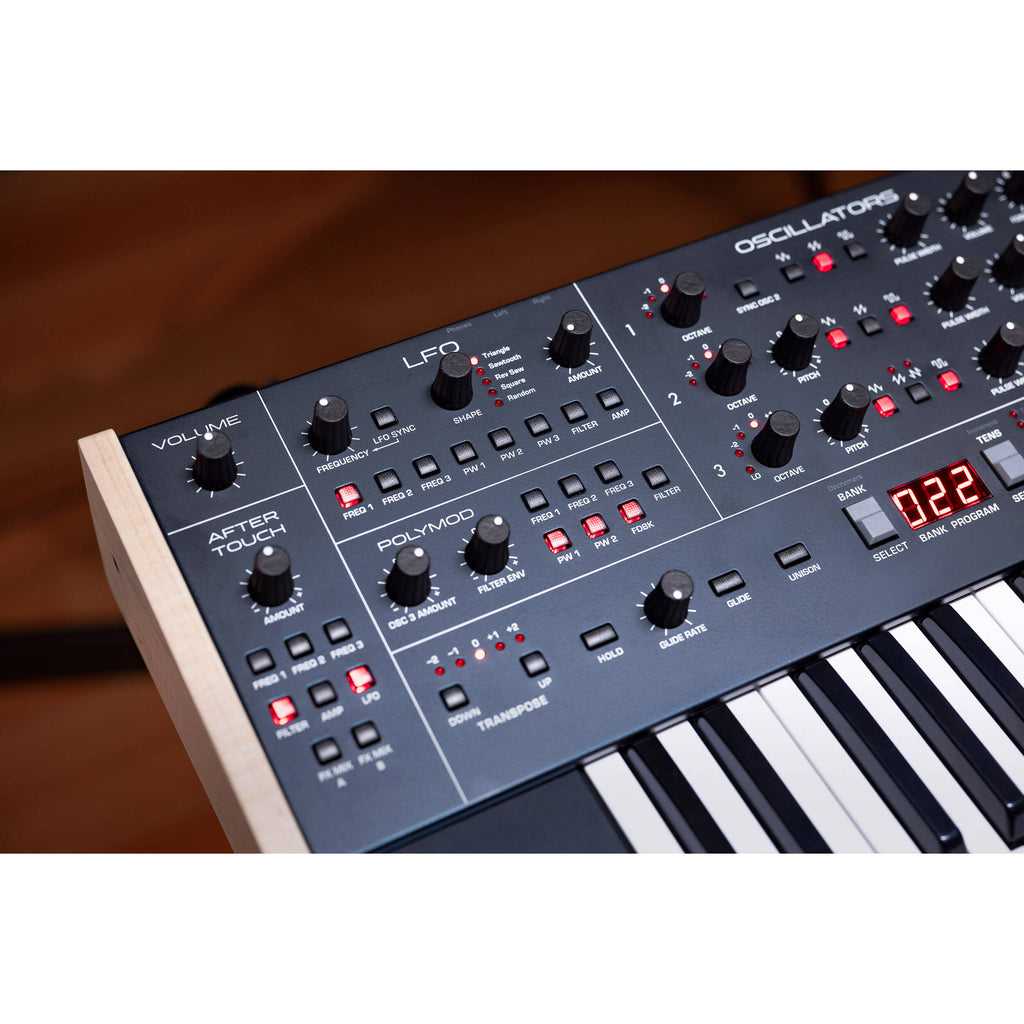 Sequential Trigon-6 synthesizer with a compact black control panel, multiple knobs, and patch points for sound shaping.