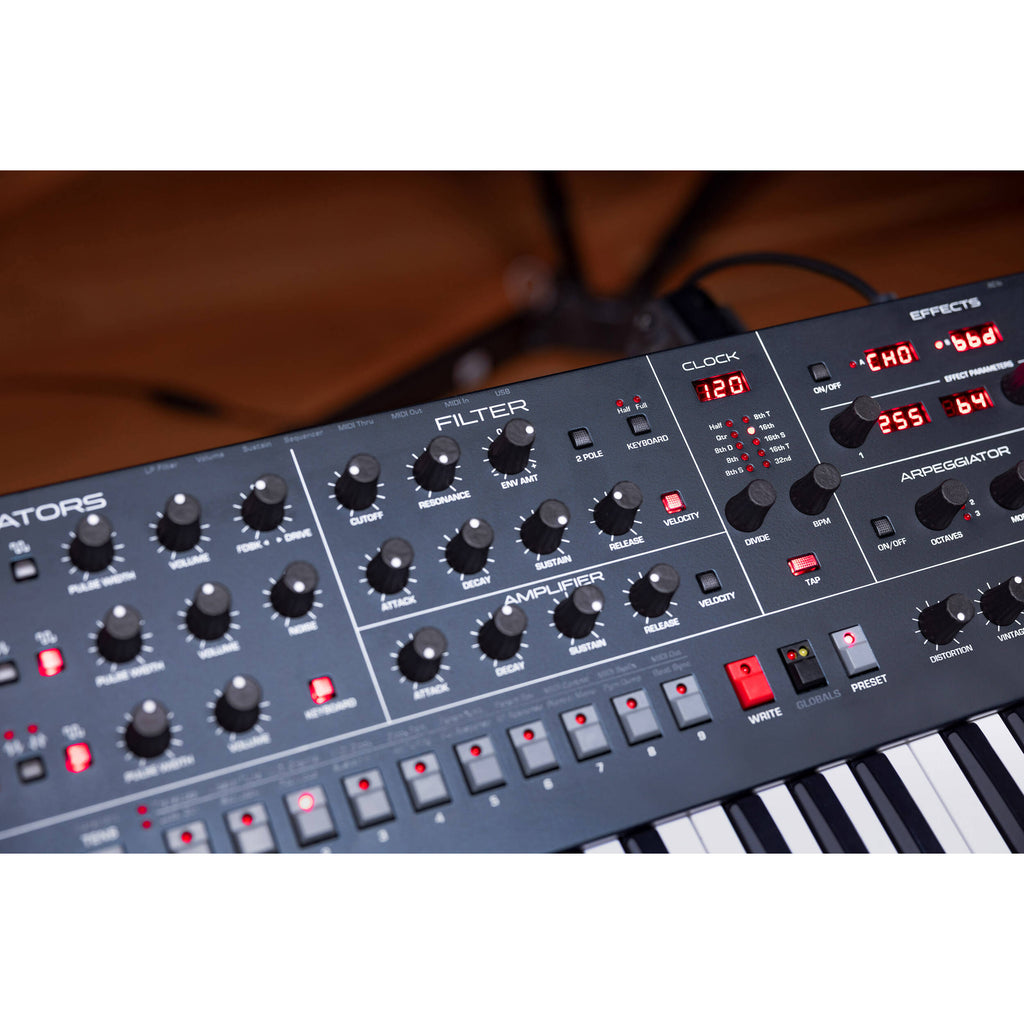 Sequential Trigon-6 synthesizer with a sleek control panel and multiple knobs and switches for sound shaping.