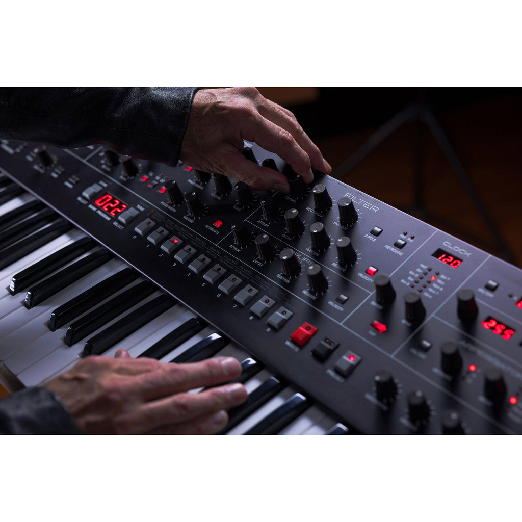 Sequential Trigon-6 synthesizer with a sleek black panel, multiple knobs and buttons, and a compact design for music production.
