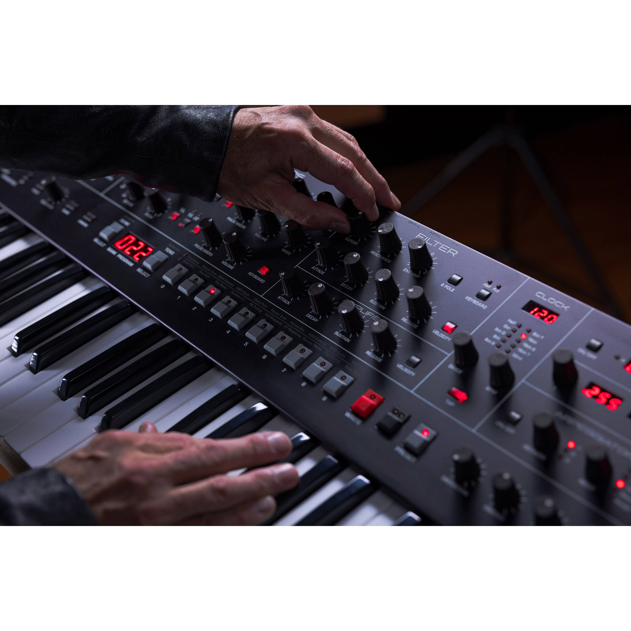 Sequential Trigon-6 synthesizer with a sleek black panel, multiple knobs and buttons, and a compact design for music production.