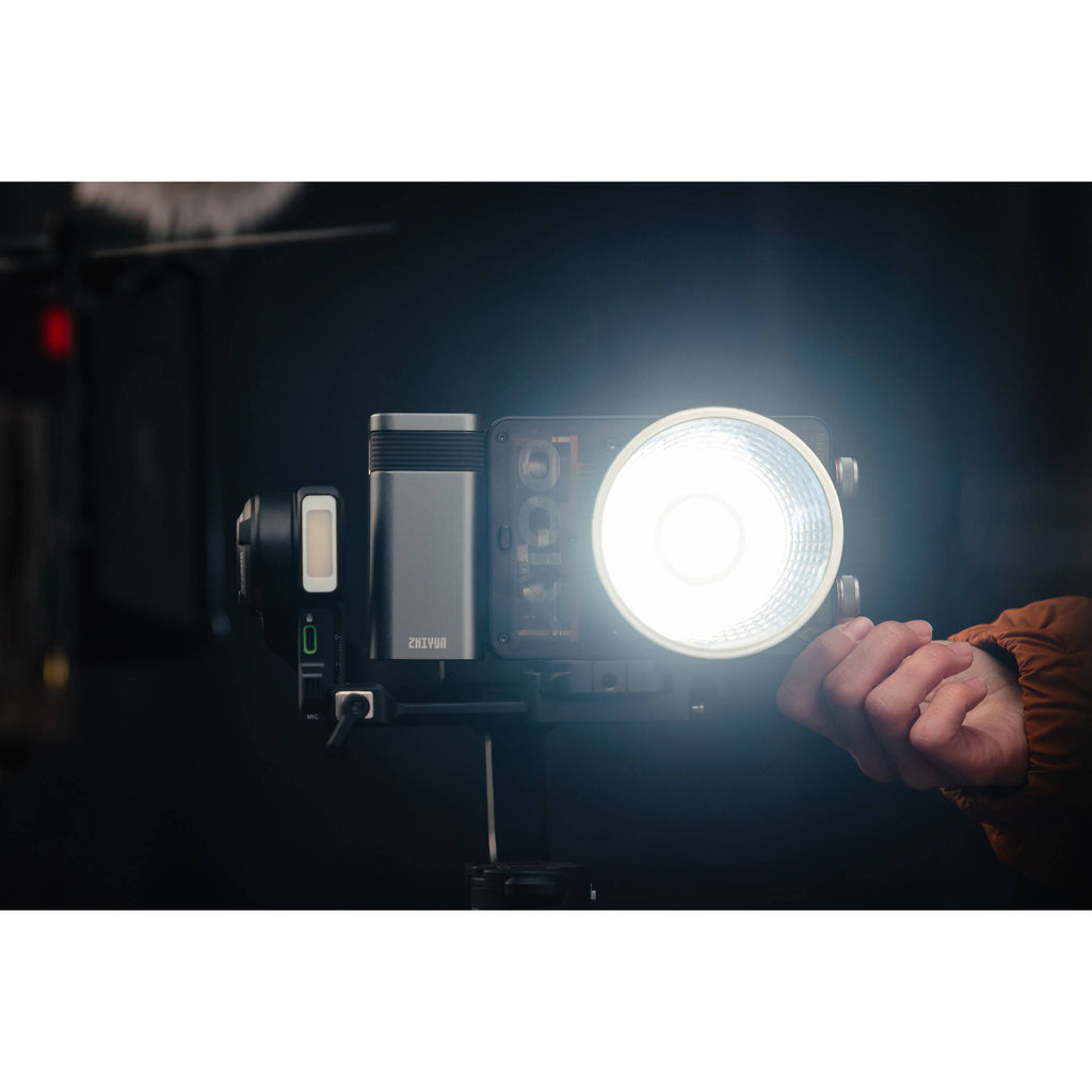 Zhiyun Molus X100 Pro bi-color LED light with adjustable brightness and color temperature, shown with mounted controls and stand.