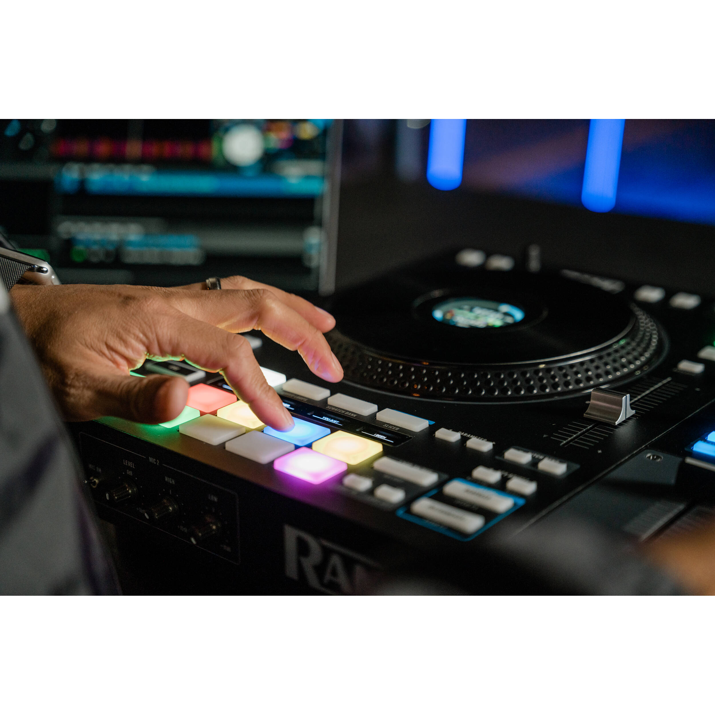 Rane Four DJ controller with dual jog wheels, mixer controls, and colorful pads for professional DJ mixing and performance.