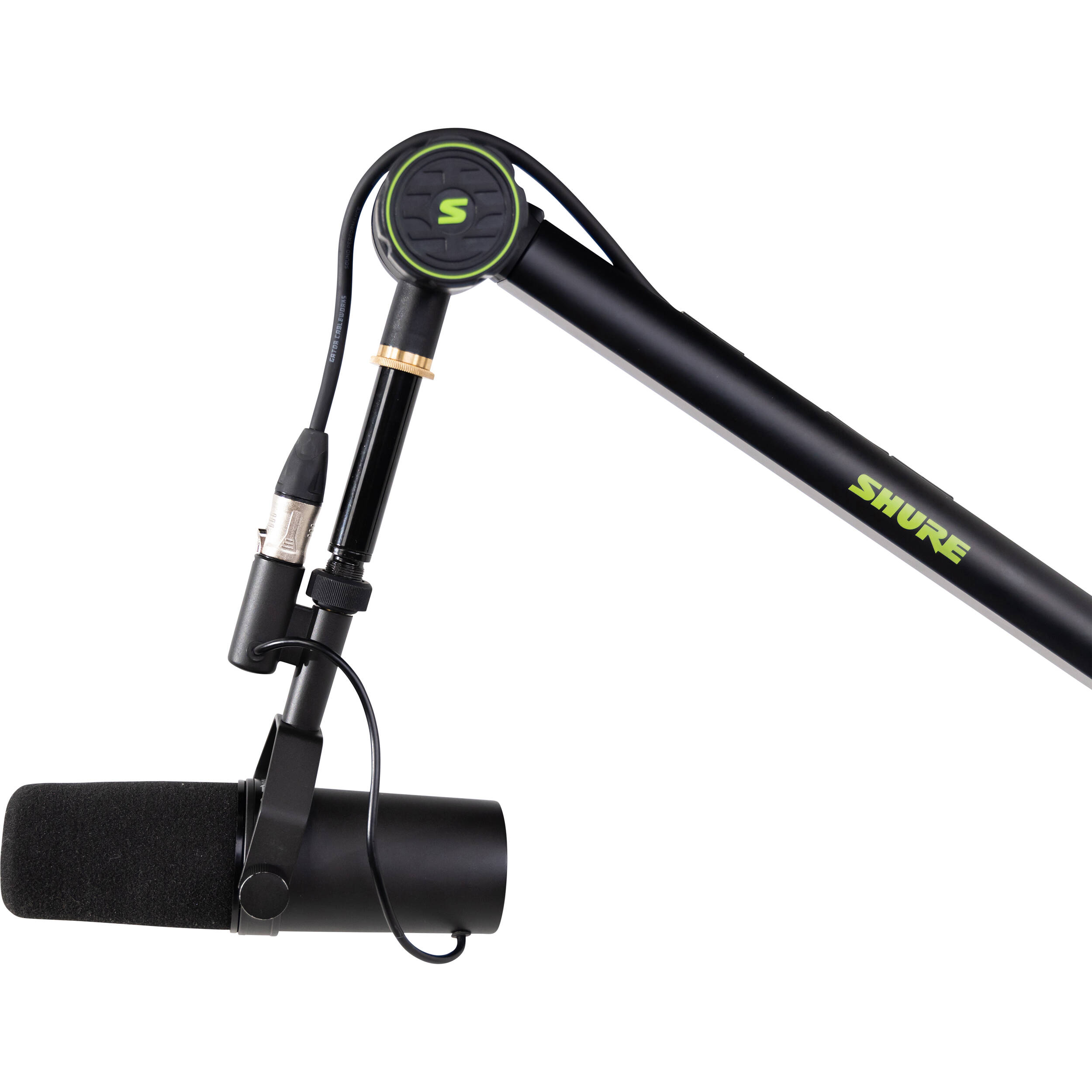 Shure SH-BROADCAST1 broadcast microphone arm mounted on a desk with adjustable arm and shock mount for professional audio recording.