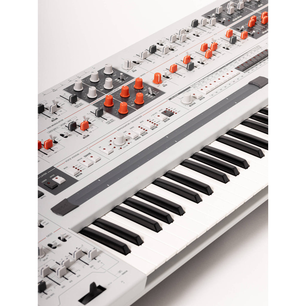 UDO Audio Super Gemini synthesizer with sleek black control panel and multiple knobs, buttons, and a display screen.