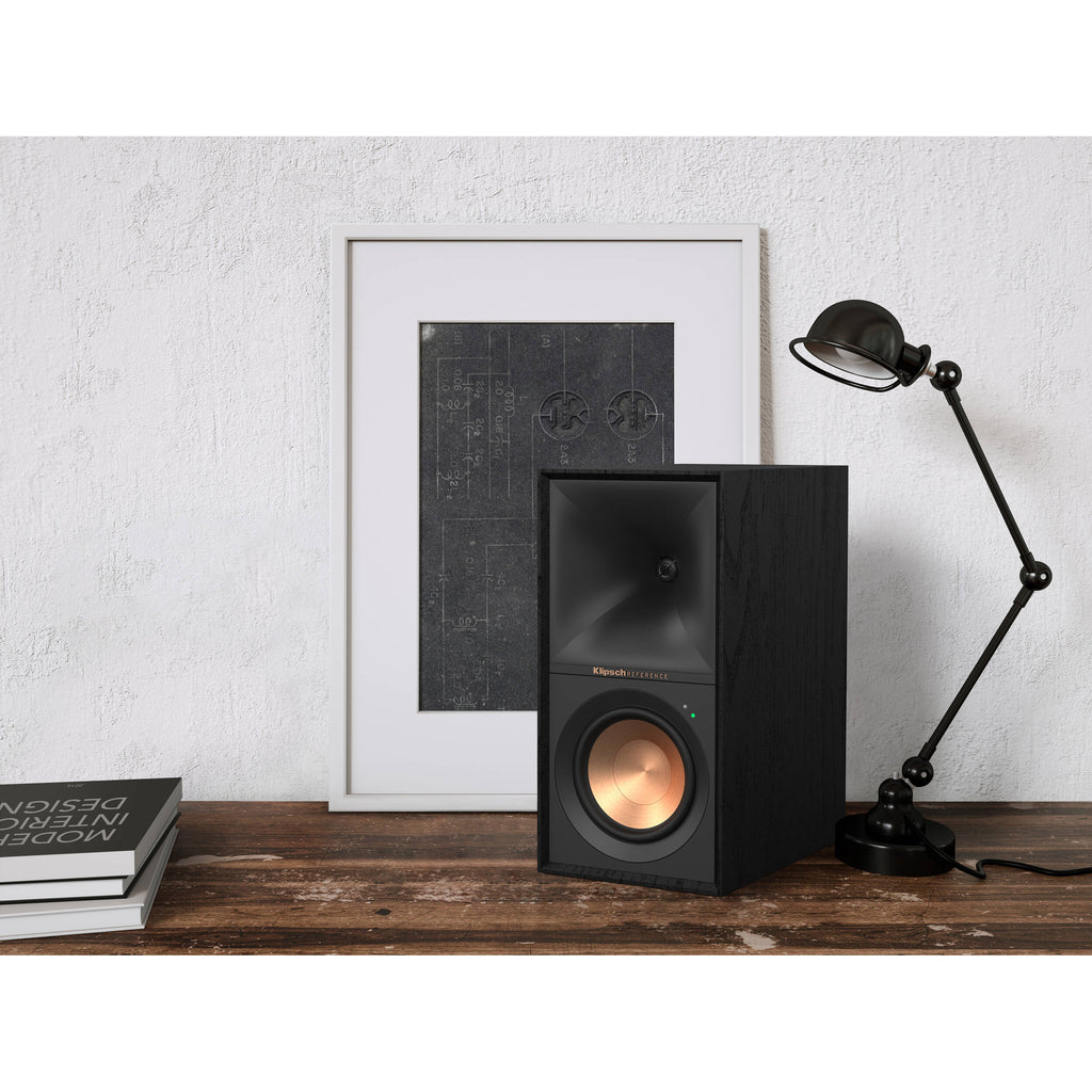 Black Klipsch R-50PM wireless speakers with sleek design and control buttons, shown in a close-up image.