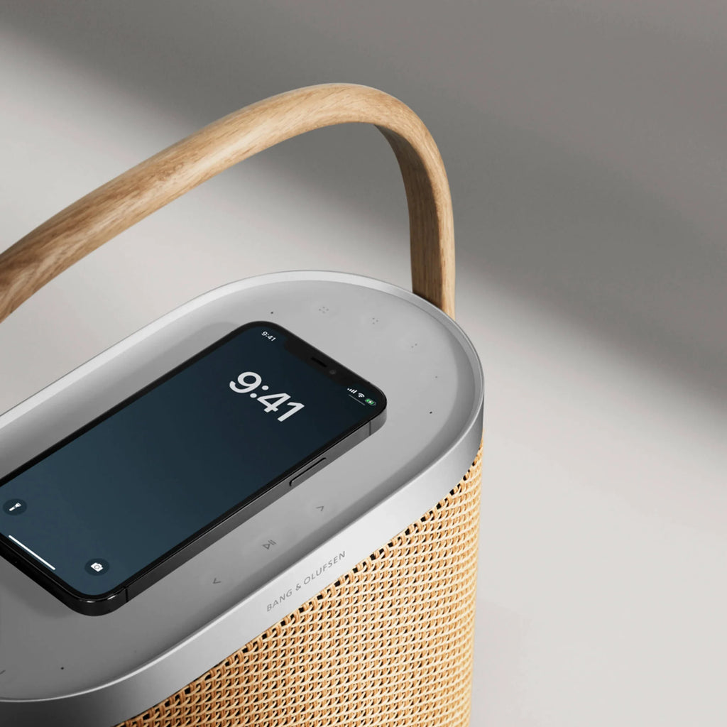 Bang & Olufsen Beosound A5 portable speaker in black, showing its sleek design with fabric grille and control buttons on top.