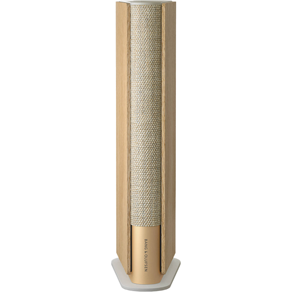 Bang & Olufsen Beosound Emerge wireless speaker in gold tone with sleek design and fabric-covered exterior.