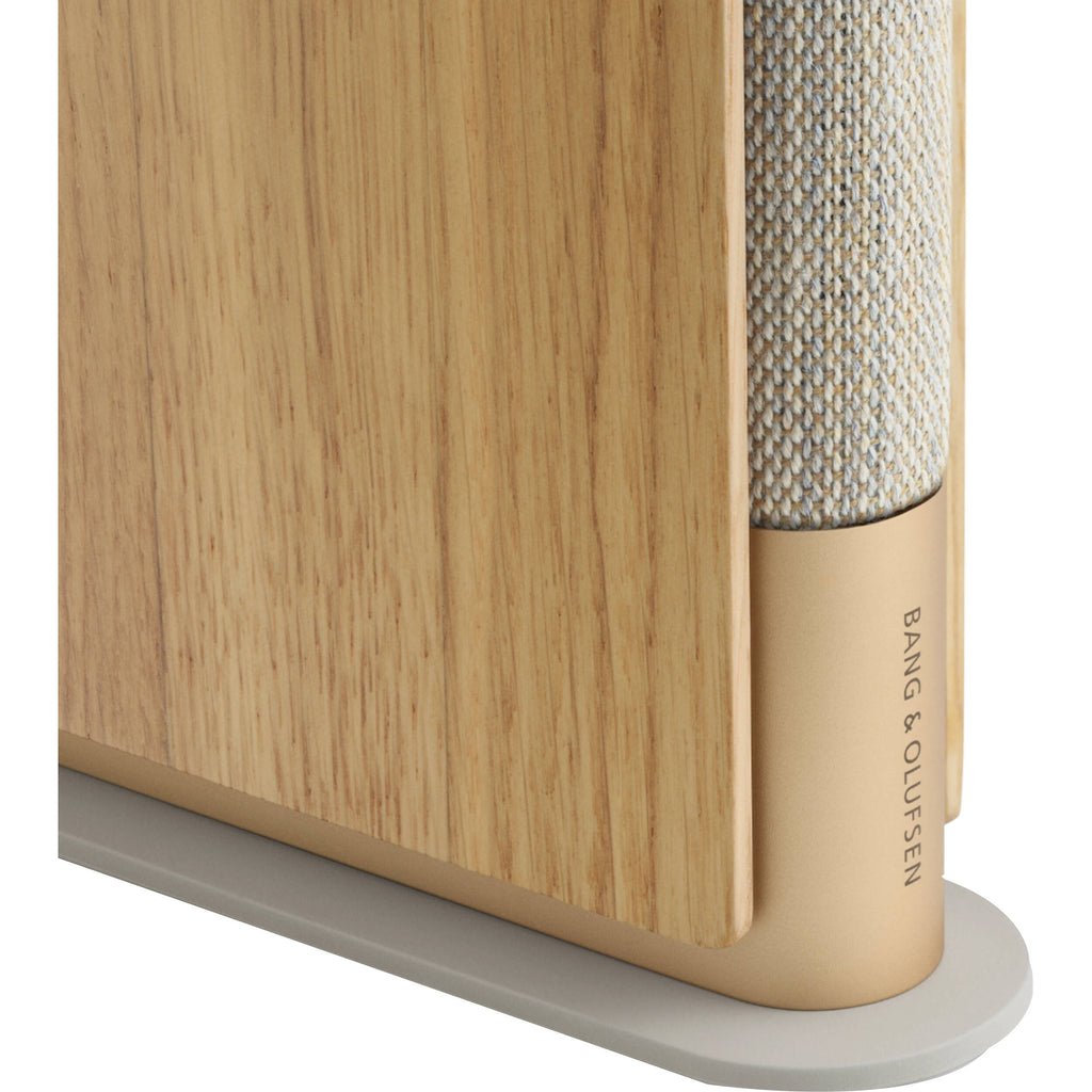 Bang & Olufsen Beosound Emerge wireless speaker in gold tone with sleek design and compact size.