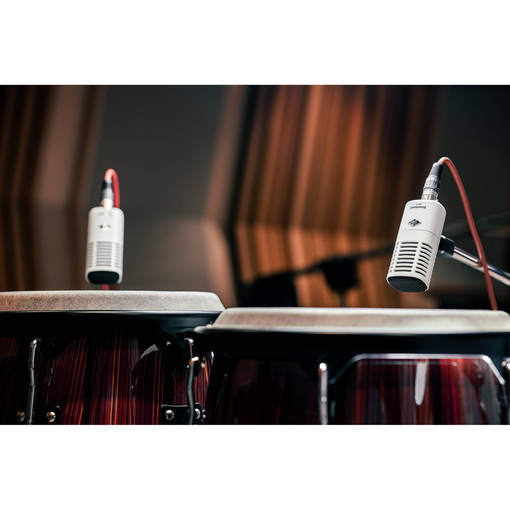 Universal Audio SD-7 dynamic microphone shown with a sleek black design and built-in grille for professional sound recording.