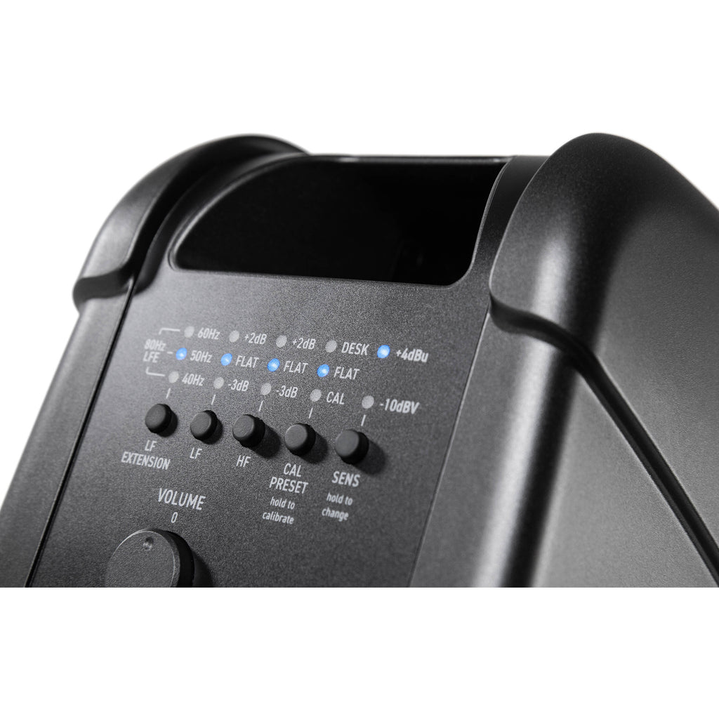 IK Multimedia iLoud MTM MK2 active nearfield monitors on a desk with audio equipment, showcasing their compact design and speaker drivers.