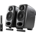 IK Multimedia iLoud Micro Monitor Pro active nearfield monitors showing dual speakers and control interface in a studio setup.