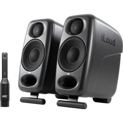 IK Multimedia iLoud Micro Monitor Pro active nearfield monitors showing dual speakers and control interface in a studio setup.