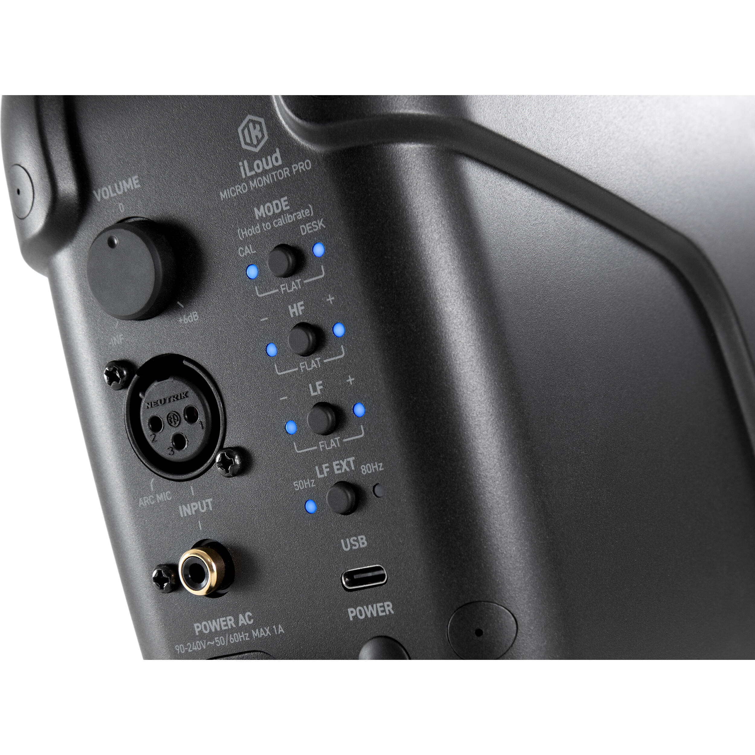 IK Multimedia iLoud Micro Monitor Pro active nearfield monitor speakers shown on a studio desk with audio equipment.