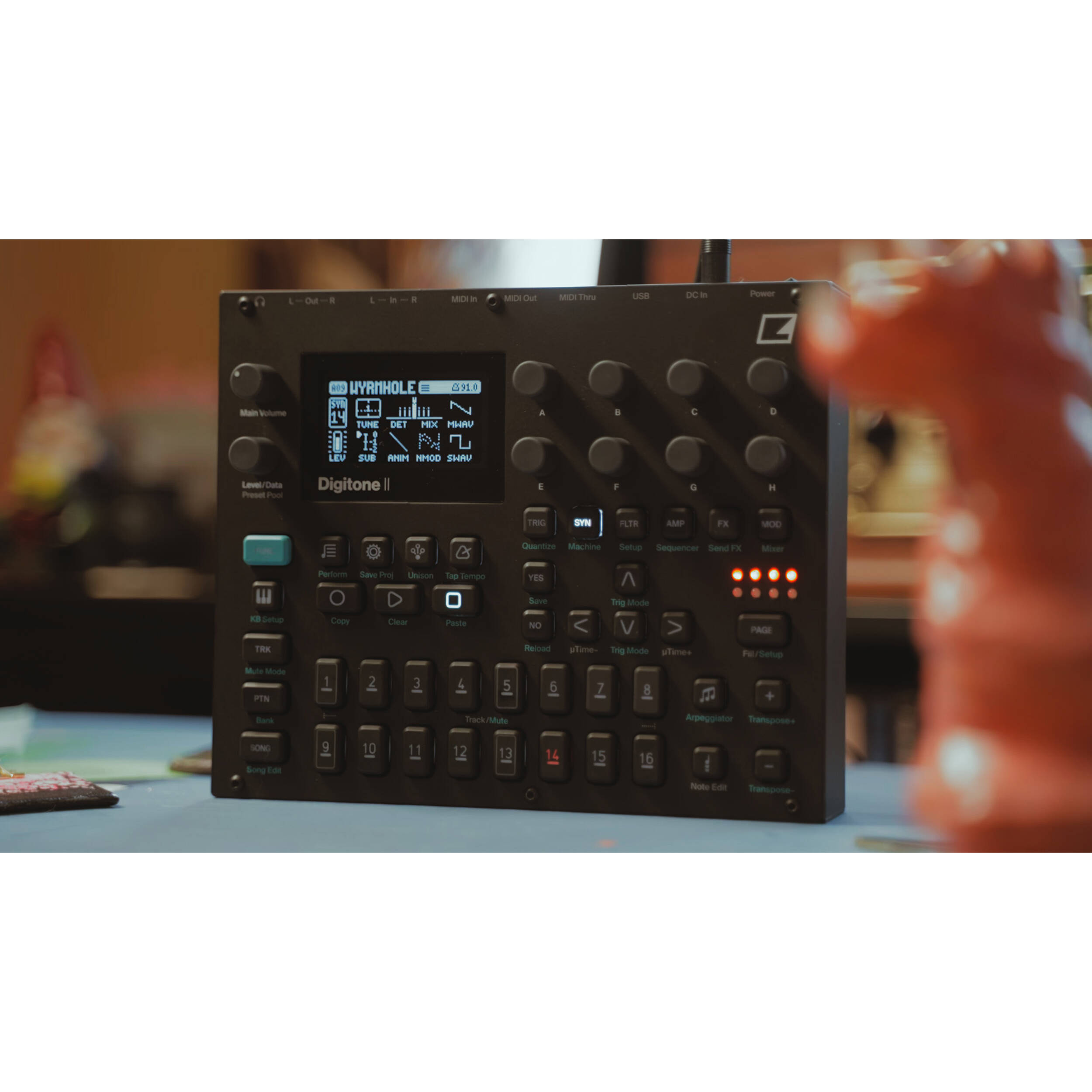Elektron Digitone II synthesizer with multiple control knobs and a digital display, showcasing its compact, modern design.