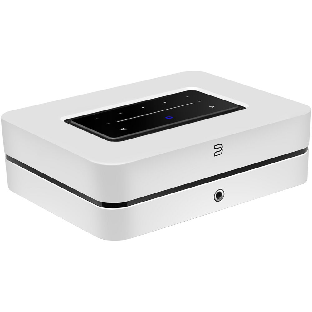 Bluesound Powernode music streamer connected to home audio system with display and control buttons visible.
